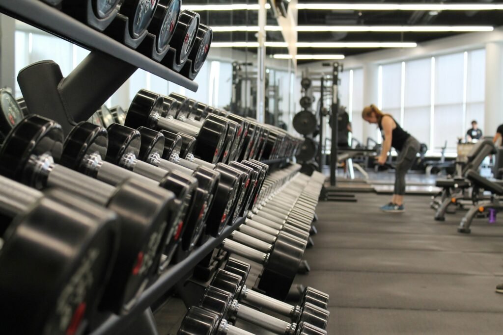 Photo by Danielle Cerullo woman standing surrounded by exercise equipment