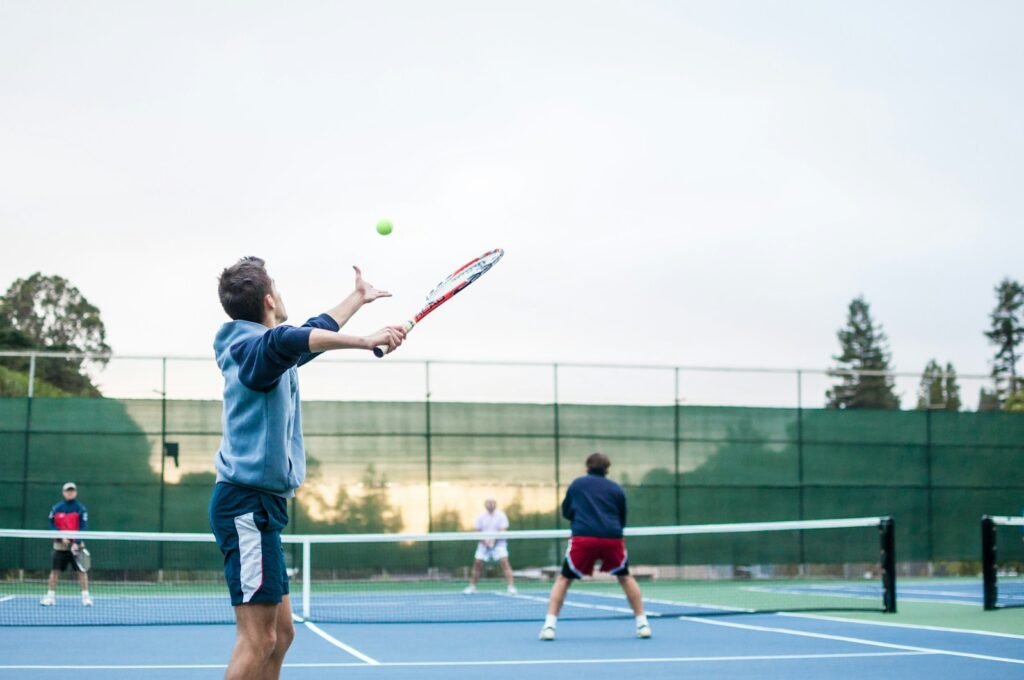 Photo by J. Schiemann four men playing double tennis during daytime